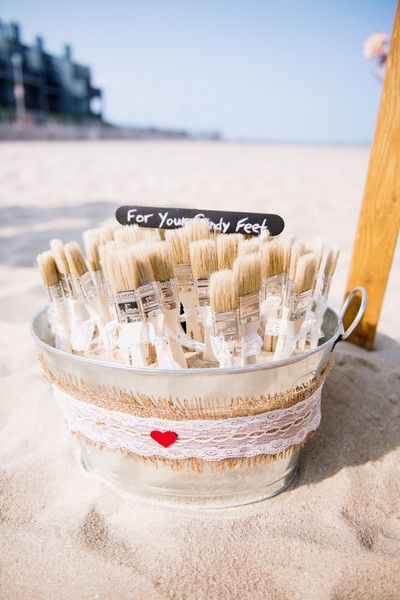 "For your sandy feet!" Your guests will appreciate the thought of paintbrushes to brush away sand at your beach wedding! {@offbeetpro}